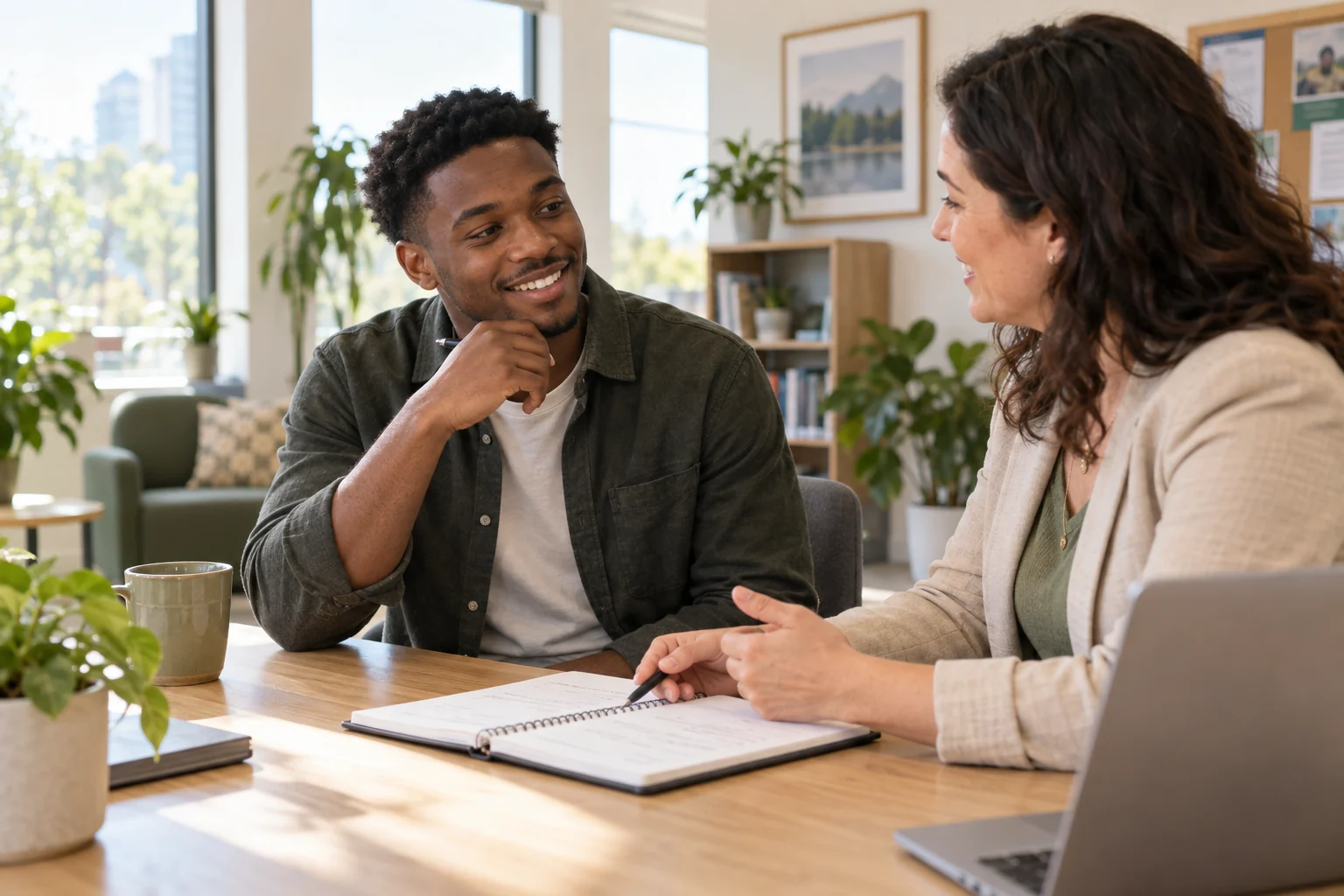 A young job seeker discussing interview preparation with a career coach